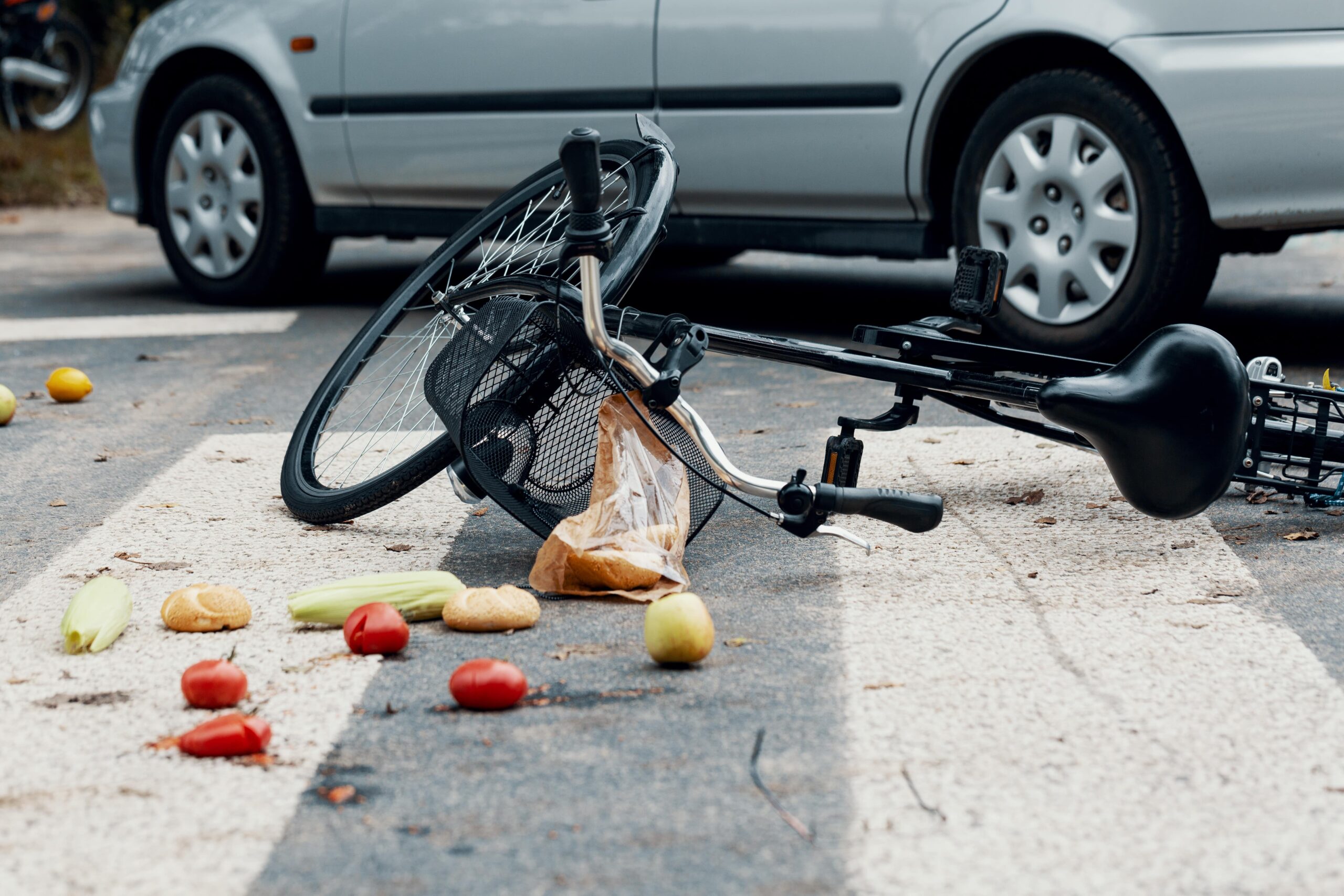 Bicycle Laying On A Pedestrian Walk With Some Vegetables Spread Out